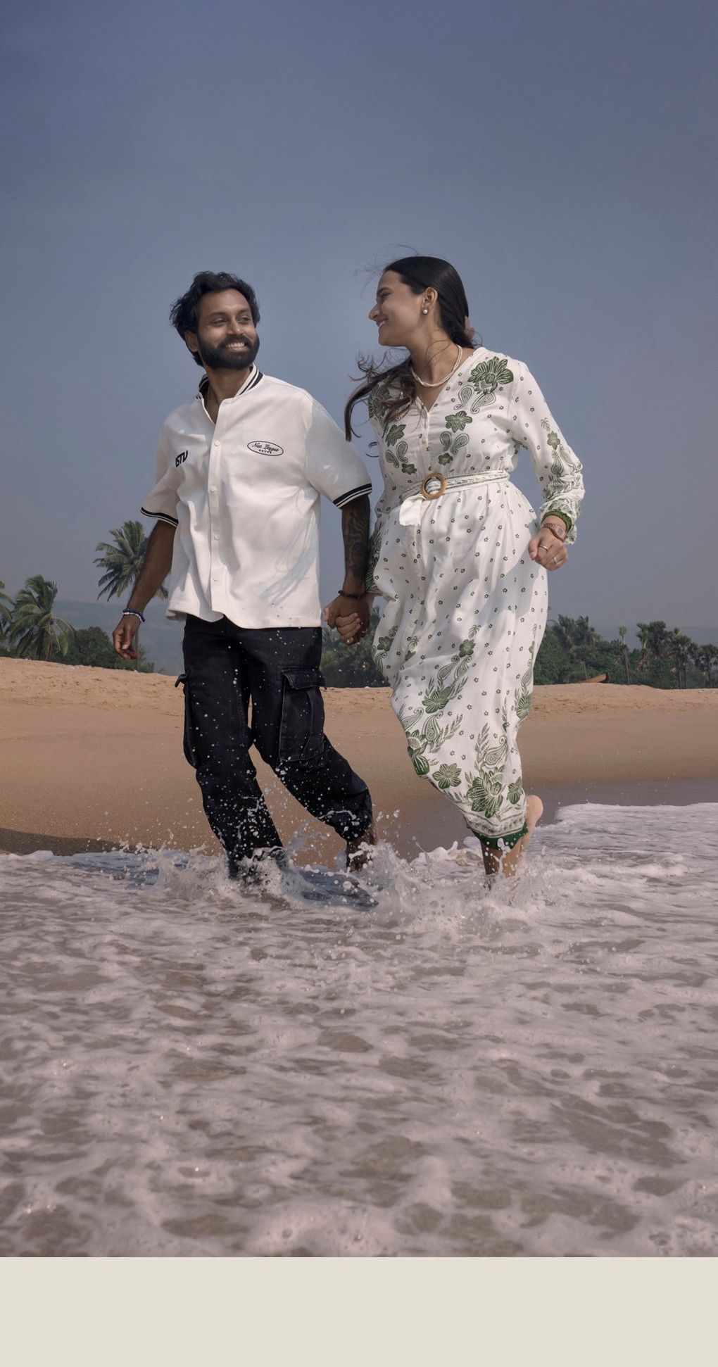 Couple running through the surf